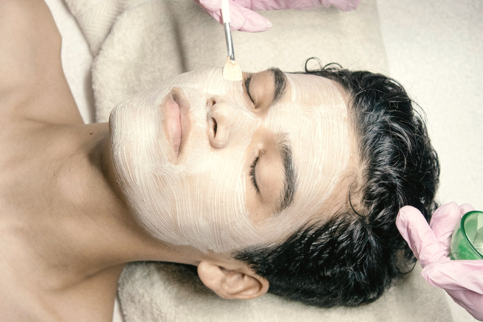 A chemical peel solution being brushed onto a mans face