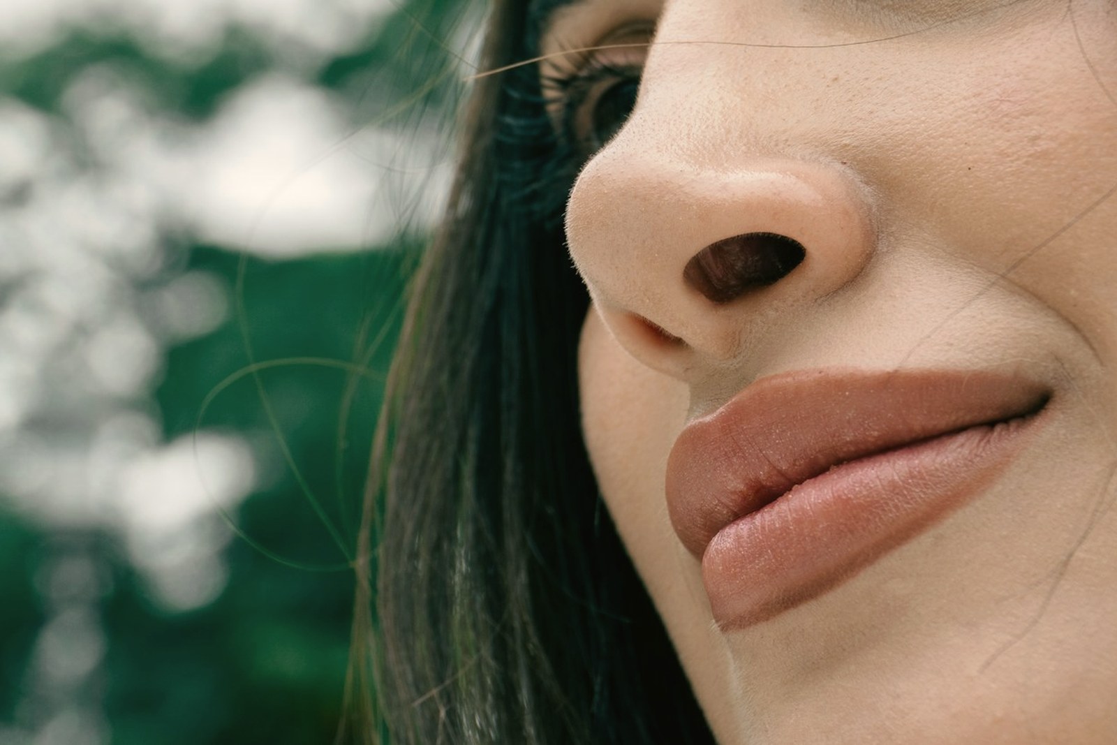 Close up of a womans lips and lip border where filler migration first becomes visible