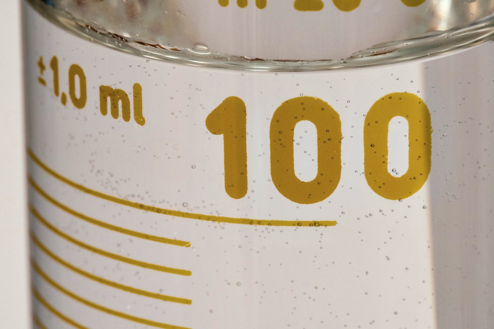 A laboratory flask holding an amber solution