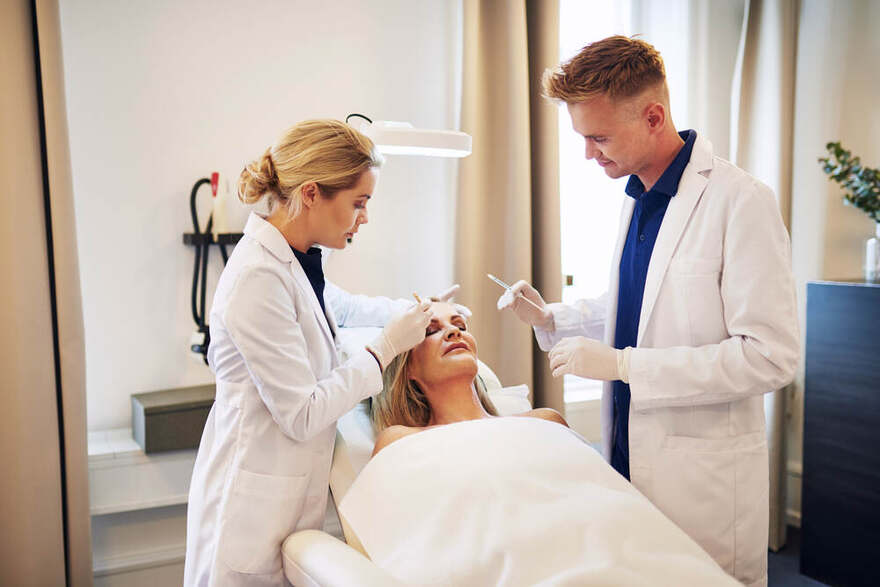 Doctor performing precision injection consultation at Bar Beauty Medical Toronto